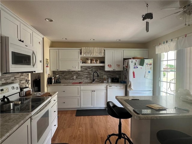 1215 Westside Dr, Mt Zion, IL 62549 - kitchen with white appliances, decorative backsplash, open shelves, dark wood finished floors, and recessed lighting