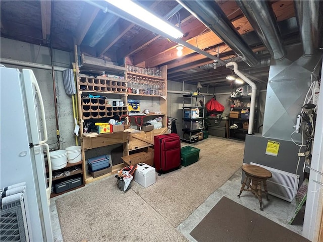 1215 Westside Dr, Mt Zion, IL 62549 - unfinished basement featuring freestanding refrigerator and heating unit