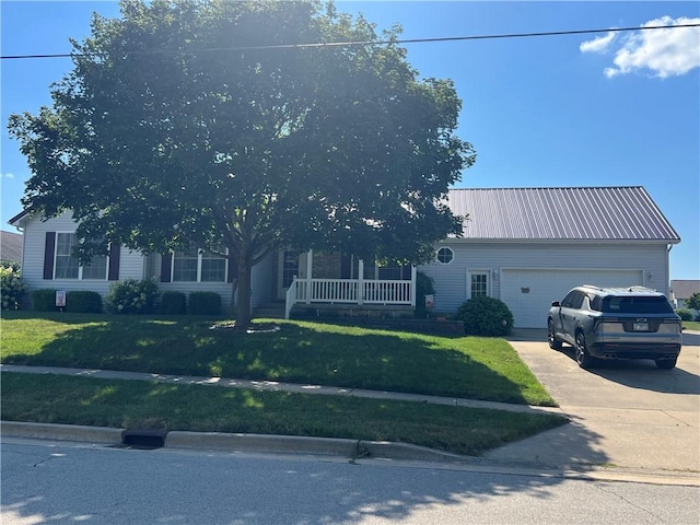 1215 Westside Dr, Mt Zion, IL 62549 - view of property hidden behind natural elements featuring an attached garage, driveway, a front lawn, and a porch