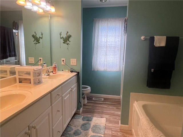 1215 Westside Dr, Mt Zion, IL 62549 - full bathroom with double vanity, a bath, and wood finished floors