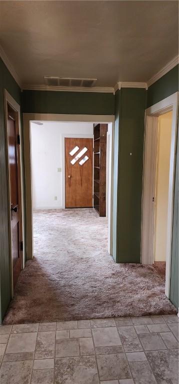 hallway with carpet flooring and ornamental molding