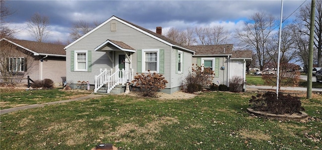 bungalow-style house with a front lawn