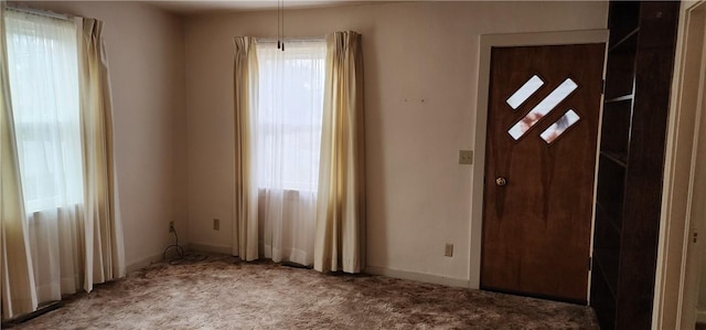 foyer entrance featuring carpet flooring