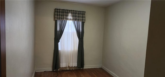 spare room with dark wood-type flooring