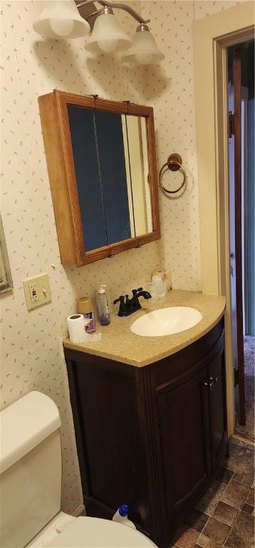 bathroom featuring vanity and toilet