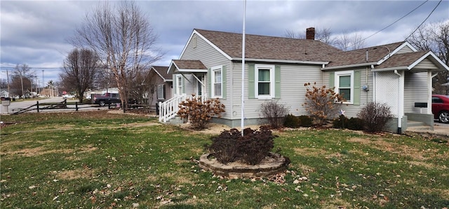 view of side of property with a lawn