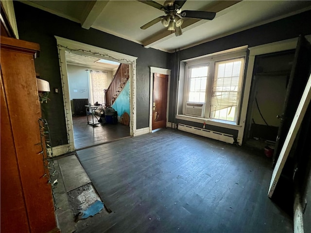 empty room featuring beam ceiling, radiator, ceiling fan, a baseboard radiator, and dark hardwood / wood-style floors