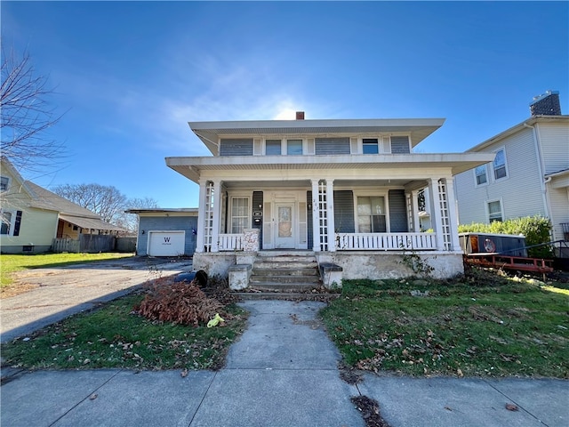 view of front of property featuring a garage and covered porch