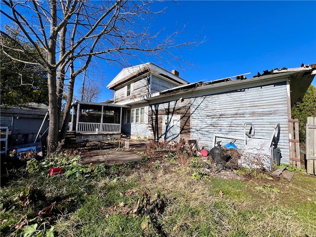 back of house featuring a sunroom