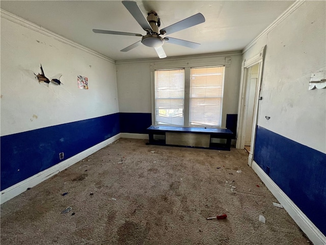 spare room featuring carpet flooring, crown molding, and ceiling fan