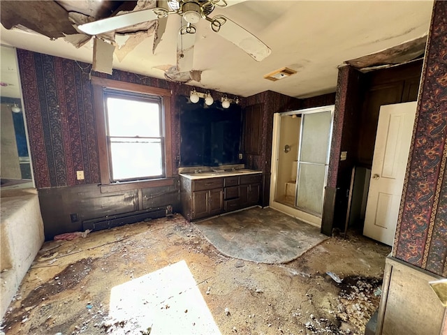 bathroom with vanity, walk in shower, and ceiling fan