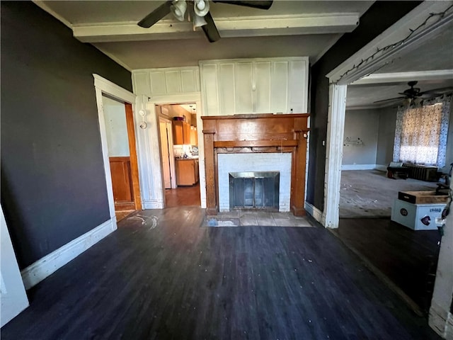 unfurnished living room with hardwood / wood-style floors, beam ceiling, and a brick fireplace