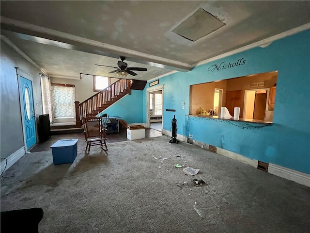 misc room with beam ceiling, carpet floors, ceiling fan, and ornamental molding