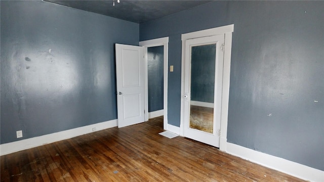 unfurnished room with hardwood / wood-style floors