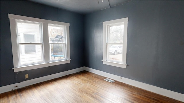 spare room featuring hardwood / wood-style floors