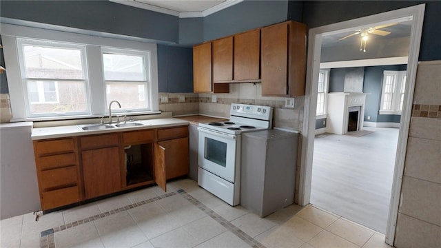 kitchen featuring sink, ceiling fan, ornamental molding, light tile patterned floors, and white electric range oven