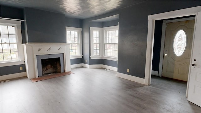 unfurnished living room featuring hardwood / wood-style flooring