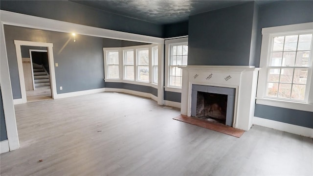 unfurnished living room featuring hardwood / wood-style flooring