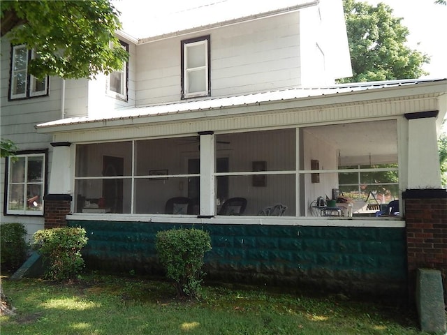 back of property featuring a sunroom