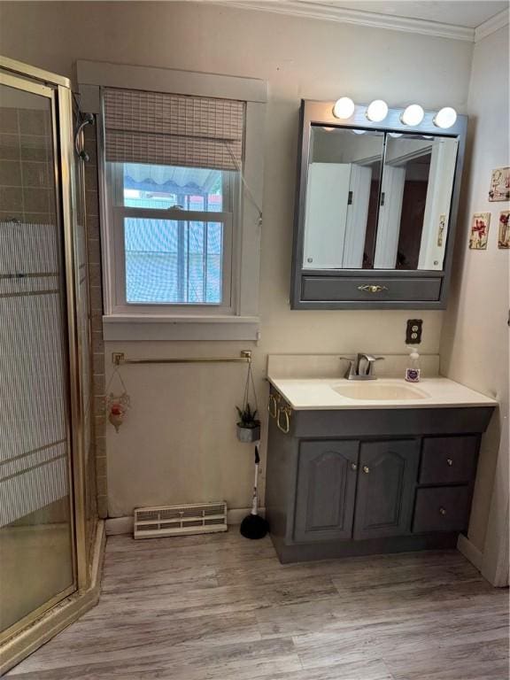 bathroom featuring vanity, hardwood / wood-style floors, crown molding, and walk in shower