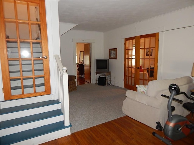 living room featuring french doors and carpet flooring