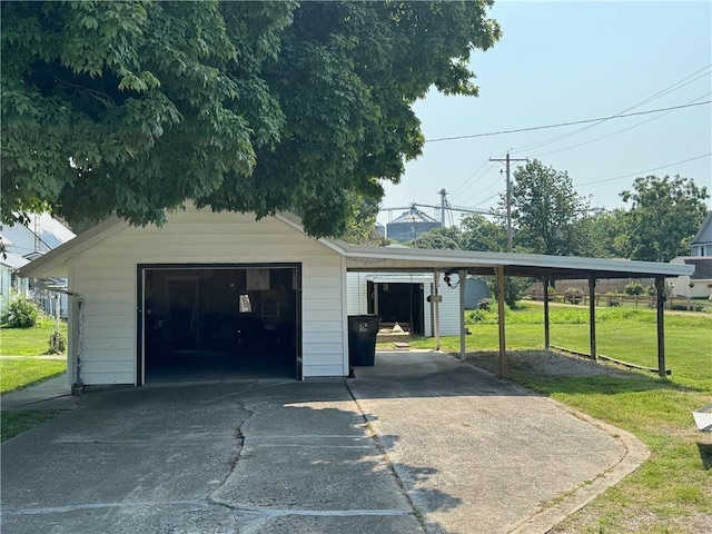 garage with a carport and a yard