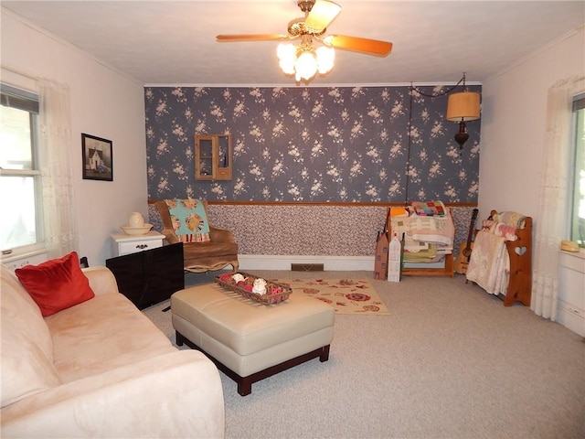 living room featuring carpet floors, ornamental molding, and ceiling fan