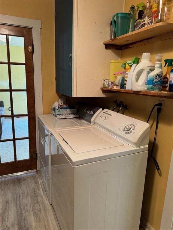 laundry area featuring wood-type flooring and washer and dryer