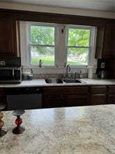 kitchen featuring sink, dark brown cabinets, and a wealth of natural light