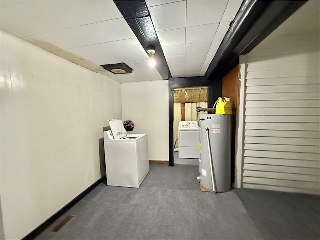 laundry room featuring laundry area, washer and clothes dryer, baseboards, and water heater