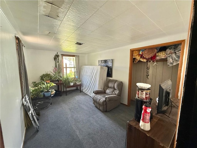 living area with carpet floors and visible vents