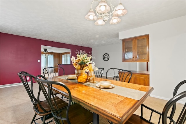 317 Holiday Dr, Decatur, IL 62526 - dining area featuring light carpet, a chandelier, and baseboards