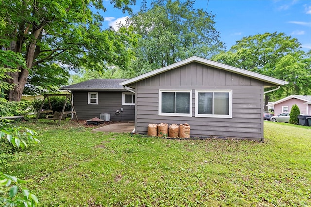 317 Holiday Dr, Decatur, IL 62526 - back of property featuring central AC unit, a yard, and a patio area