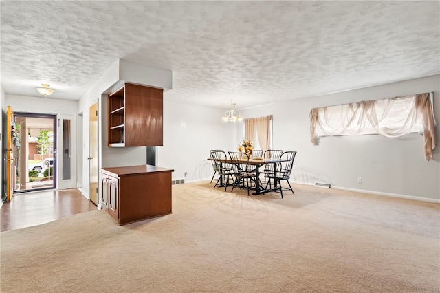 317 Holiday Dr, Decatur, IL 62526 - dining room with baseboards, light colored carpet, a chandelier, and a textured ceiling