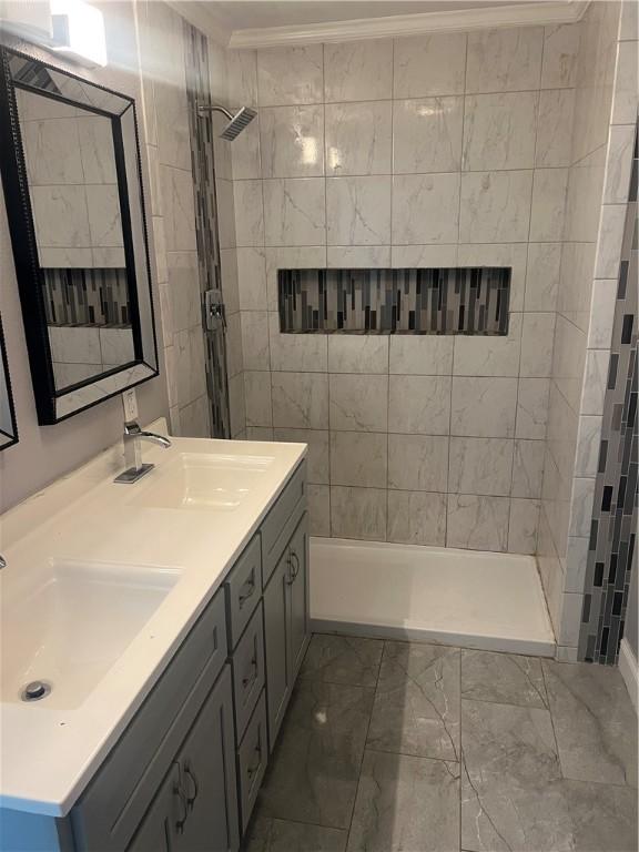 1005 Edgar Ave, Mattoon, IL 61938 - full bathroom featuring marble finish flooring, double vanity, tiled shower, and crown molding