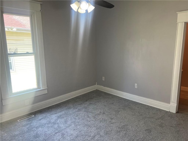 1005 Edgar Ave, Mattoon, IL 61938 - empty room with dark colored carpet and a ceiling fan