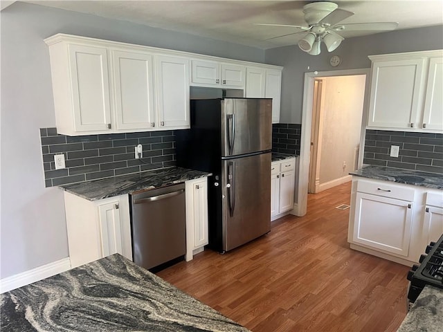 1005 Edgar Ave, Mattoon, IL 61938 - kitchen featuring appliances with stainless steel finishes, a ceiling fan, tasteful backsplash, white cabinetry, and wood finished floors