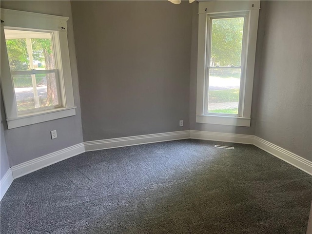 1005 Edgar Ave, Mattoon, IL 61938 - unfurnished room featuring dark colored carpet and baseboards