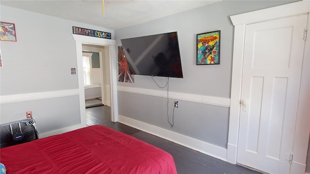 bedroom with dark hardwood / wood-style floors