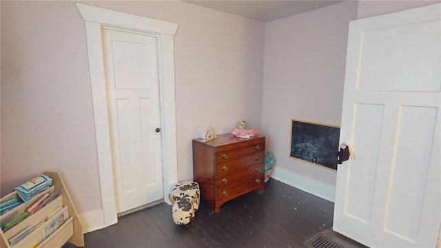 bedroom with dark hardwood / wood-style floors