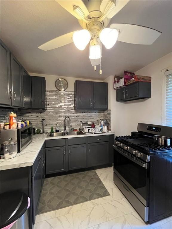 625 S Jackson St, Decatur, IL 62521 - kitchen with marble finish floor, a sink, gas stove, decorative backsplash, and ceiling fan
