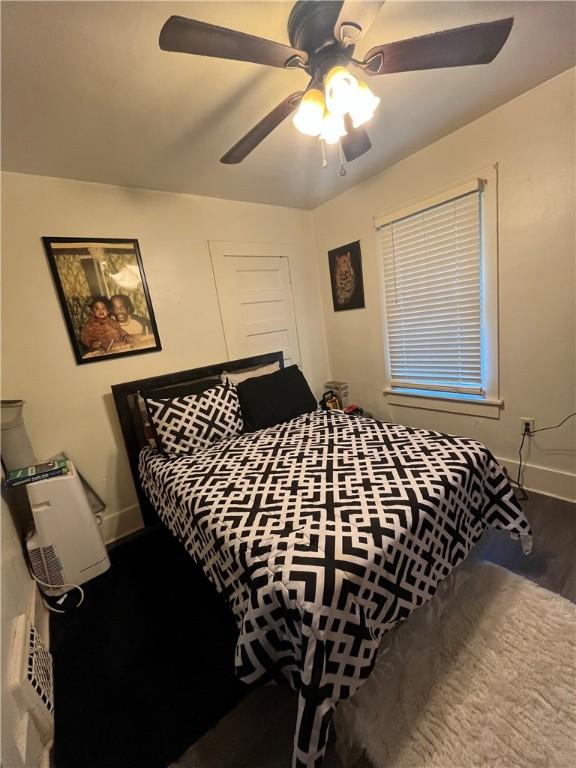 625 S Jackson St, Decatur, IL 62521 - bedroom with baseboards, a ceiling fan, and wood finished floors