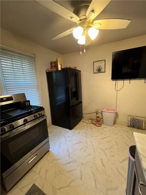 625 S Jackson St, Decatur, IL 62521 - kitchen with black refrigerator with ice dispenser, gas stove, marble finish floor, and ceiling fan