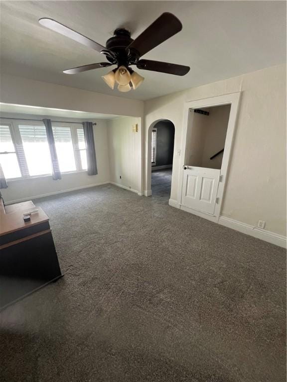 314 W Maple St, Hoopeston, IL 60942 - empty room with a ceiling fan, arched walkways, and carpet flooring