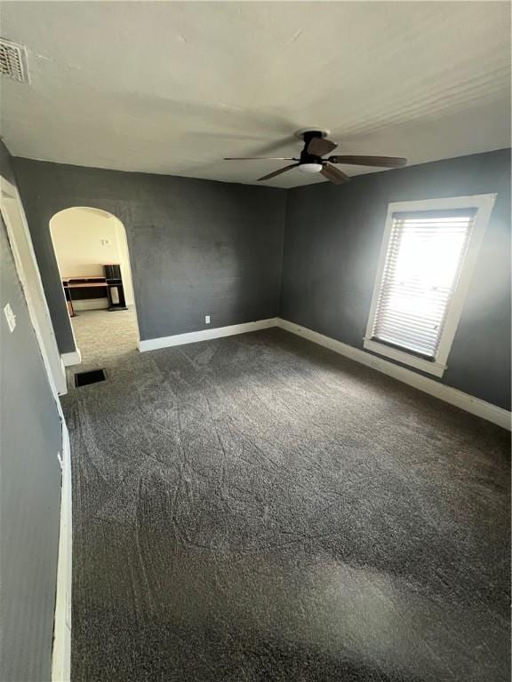 314 W Maple St, Hoopeston, IL 60942 - carpeted spare room with arched walkways and ceiling fan