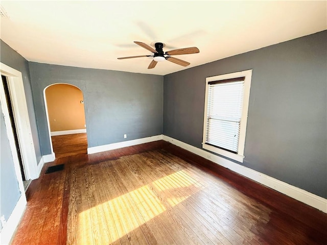 314 W Maple St, Hoopeston, IL 60942 - unfurnished room with arched walkways, hardwood / wood-style flooring, and ceiling fan