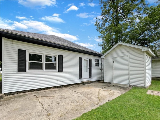 621 Piatt Ave, Mattoon, IL 61938 - rear view of house featuring a patio, roof with shingles, and a yard