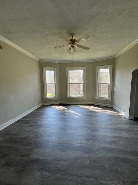 spare room with dark hardwood / wood-style floors, ceiling fan, ornamental molding, and a textured ceiling