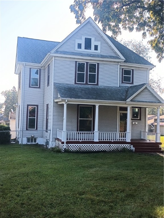 view of front facade with a front yard, a porch, and central air condition unit