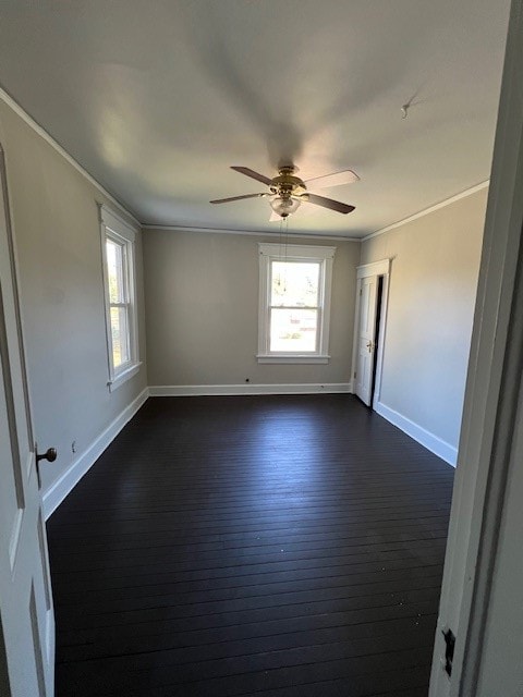 spare room with dark hardwood / wood-style flooring, ceiling fan, and ornamental molding